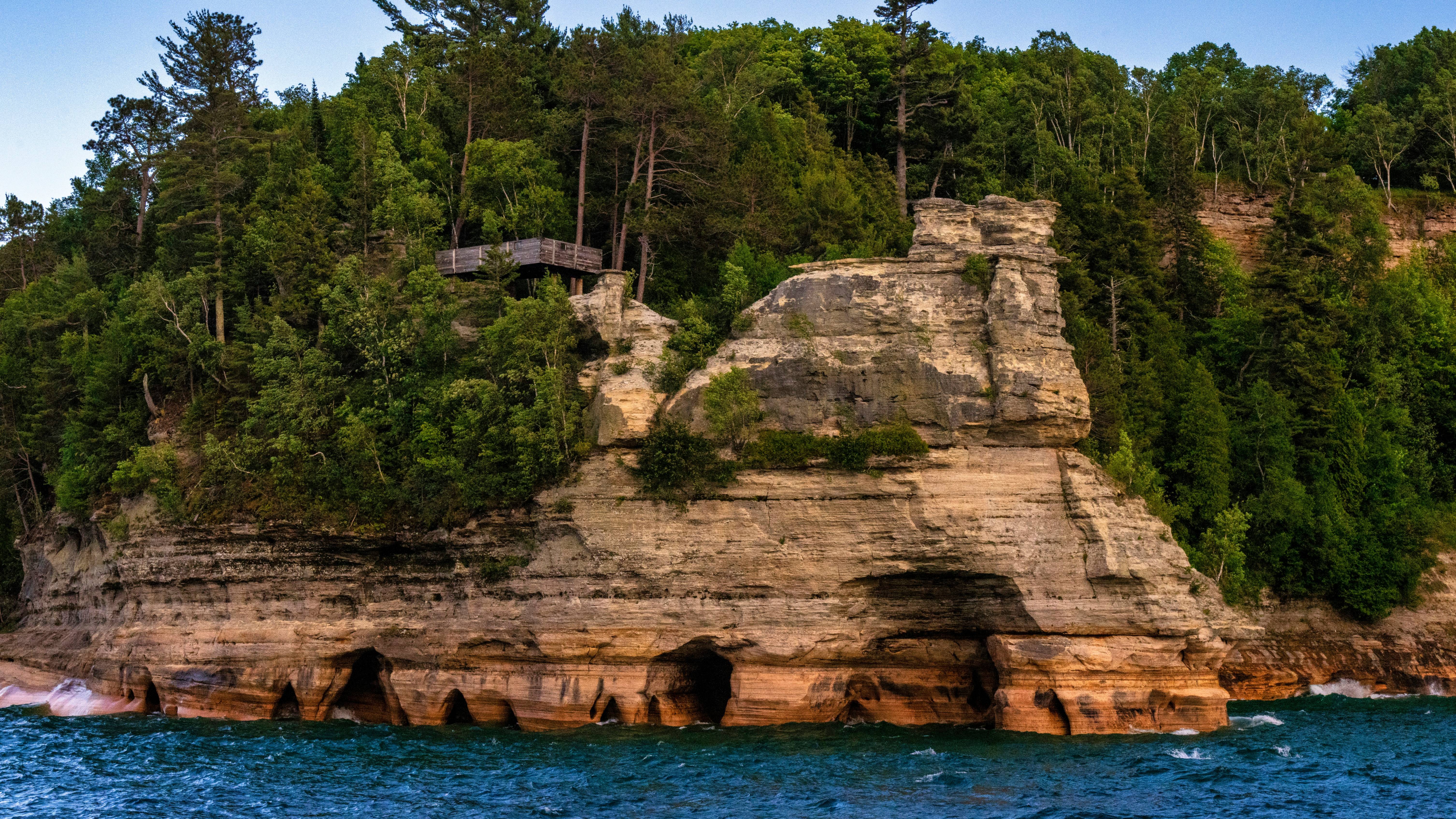 a rocky cliff with trees on it